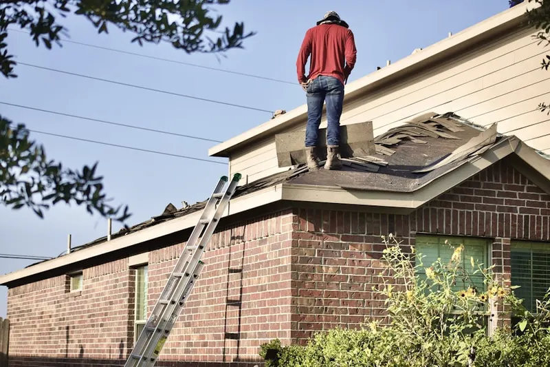 Professional roofer working on a residential roof in Bayside Village